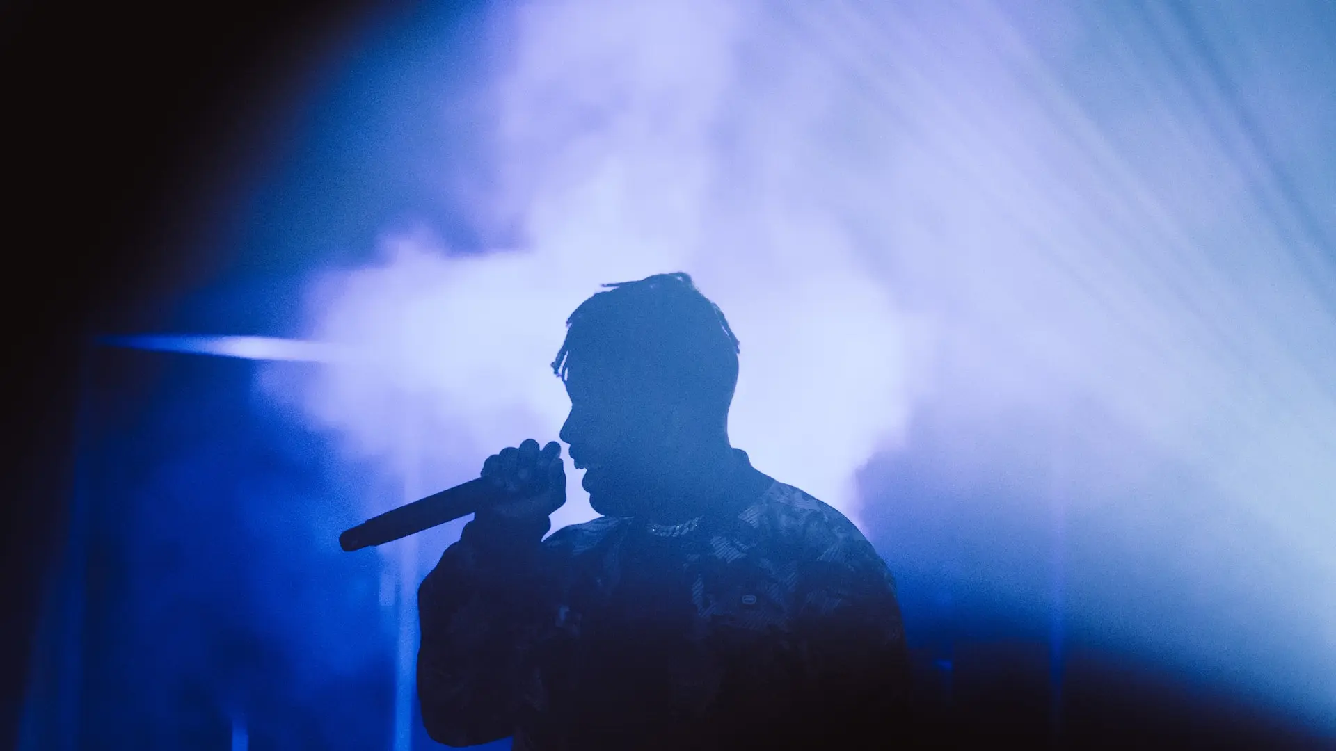 man in black jacket holding microphone